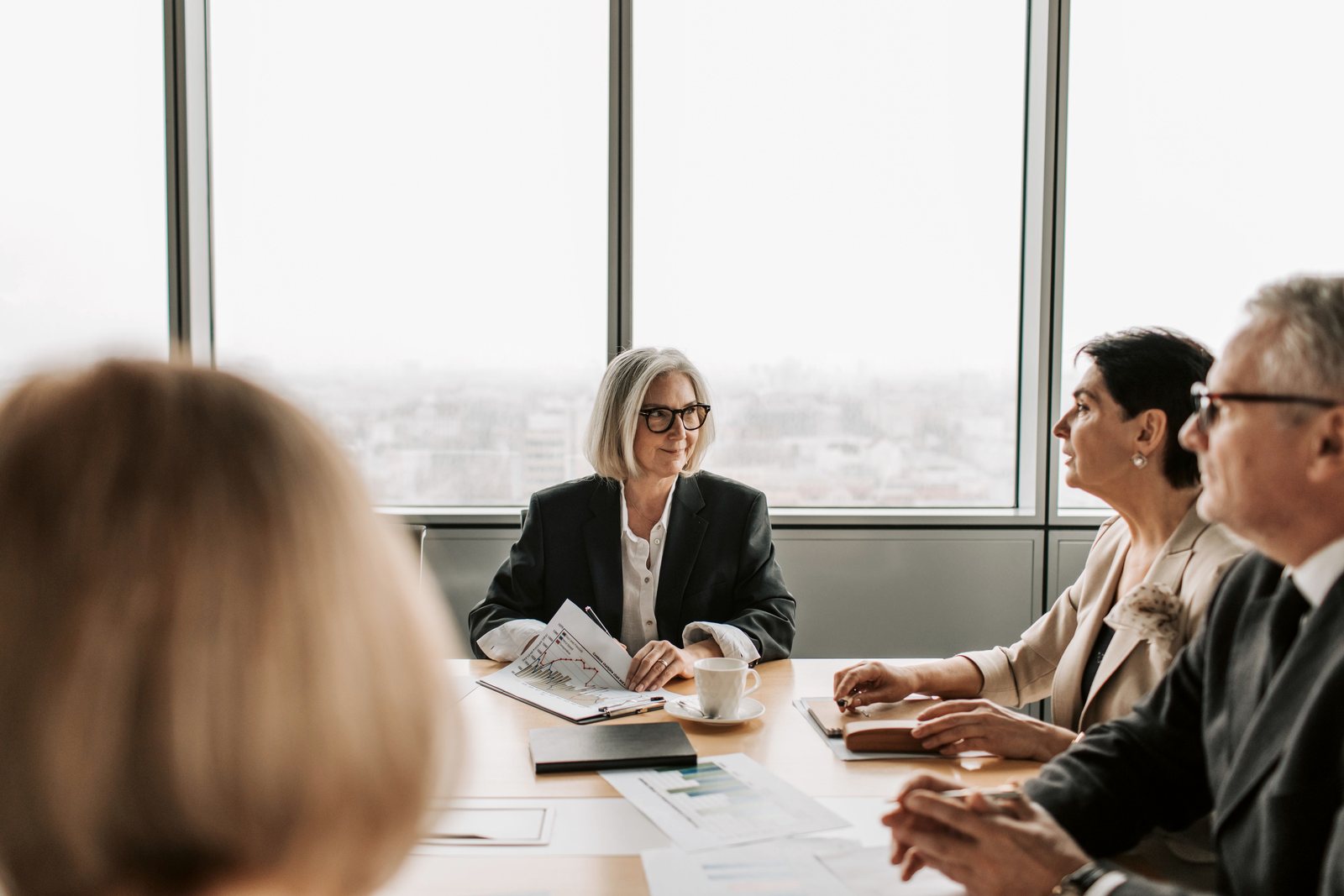 Senior business leaders in a people advisory discussion around a conference table